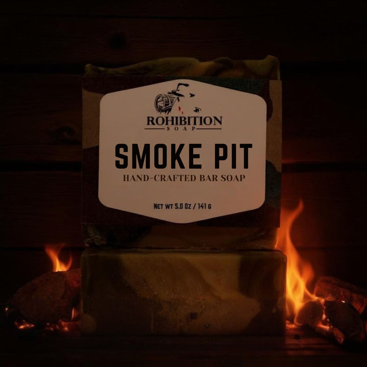Bar of soap labeled 'Smoke Pit' from Prohibition Soap in front of a fireplace.