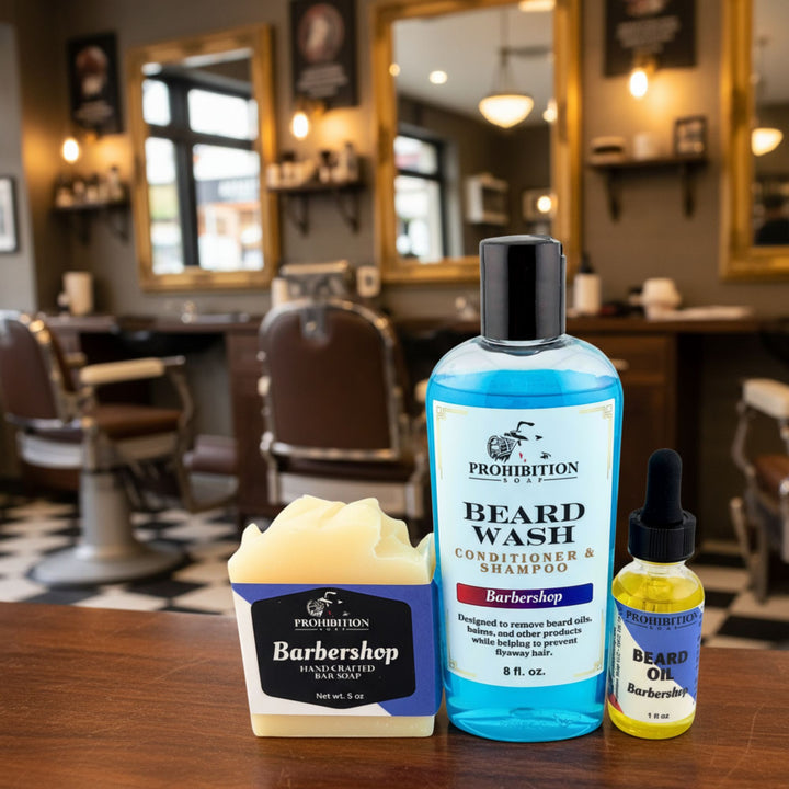 Barbershop products including beard wash, soap, and oil on a counter with barbershop chairs in the background.