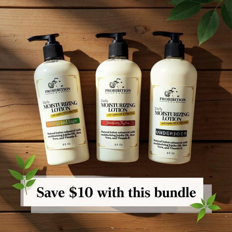 Prohibition Soap Scented Lotion Bundle featuring three Daily Moisturizing Lotions - Citrus and Sage, Strawberry Martini, and Underboss (all 8 fl oz) - arranged on rustic wood background with green leaves and 'Save $10 with this bundle' text overlay