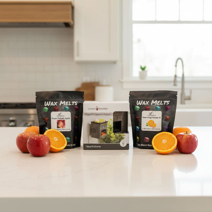 Wax melts packaging and fragrance warmer with apples and oranges on a kitchen counter
