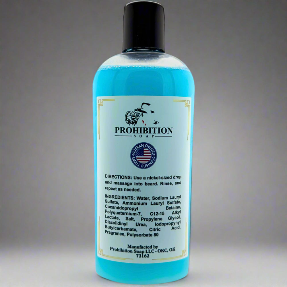Prohibition Soap Barbershop Beard Wash back label showing directions, complete ingredients list including water, sodium lauryl sulfate, and cocamidopropyl betaine, with Made in USA badge on clear bottle containing blue wash liquid