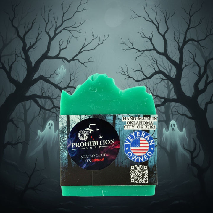 Green bar of soap with a label against a spooky forest background