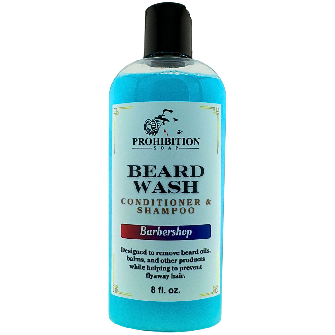 Prohibition Soap Barbershop Beard Wash conditioner and shampoo in clear 8 fl oz bottle with blue liquid on white background, showing complete product label with directions to remove beard oils, balms and other products while preventing flyaway hair