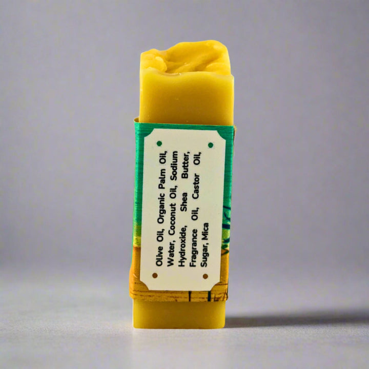 Yellow soap bar with a label on a gray background