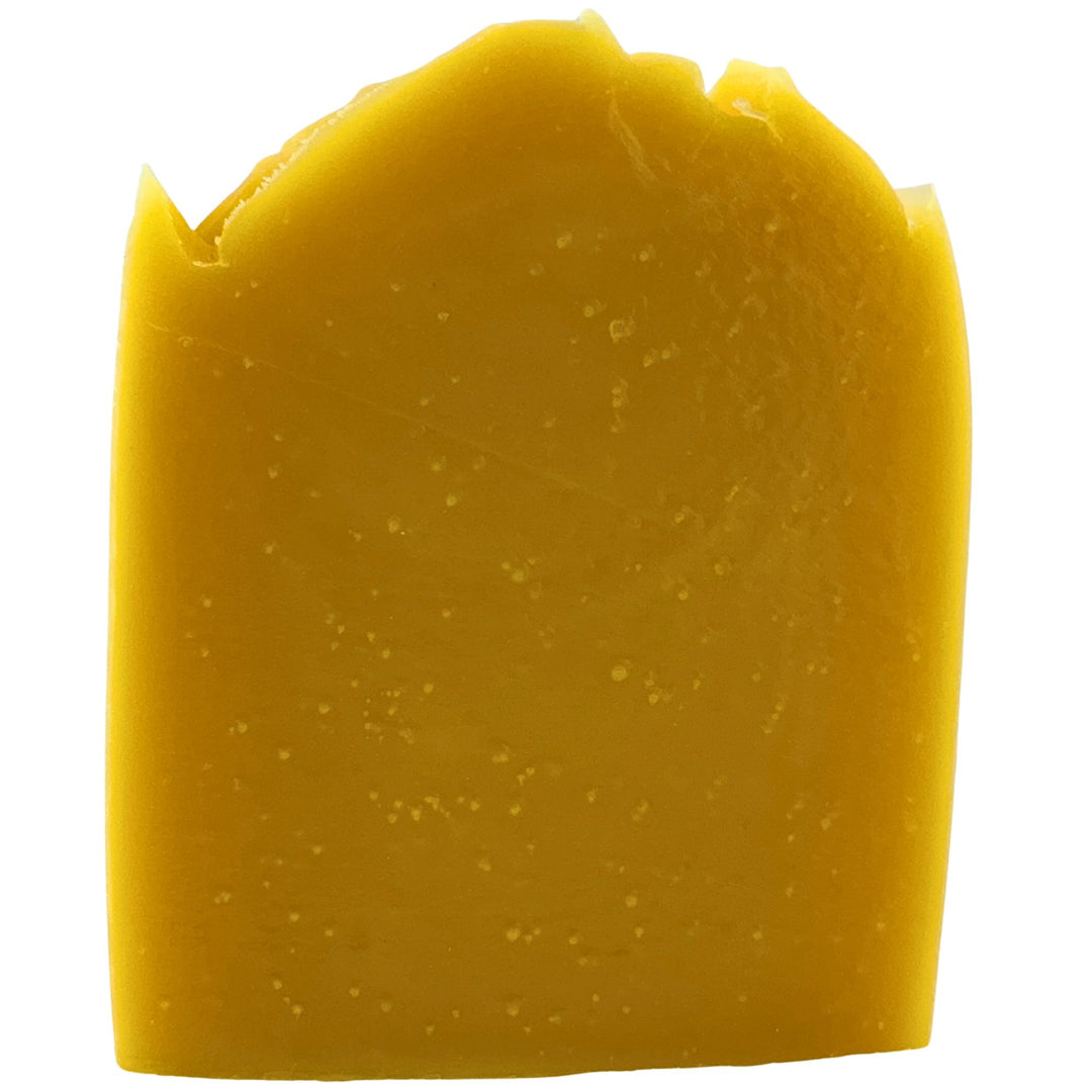 Yellow bar of soap on a white background