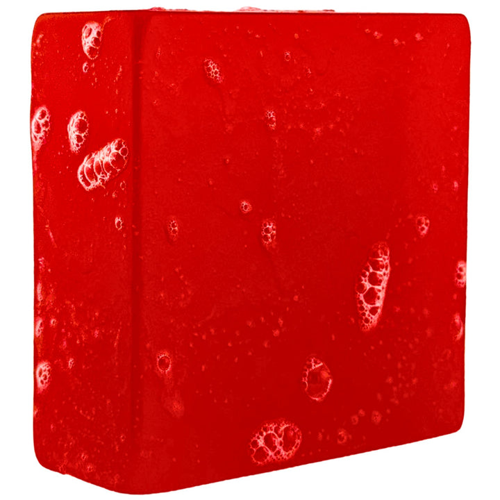 Red soap with a bubbly surface on a white background