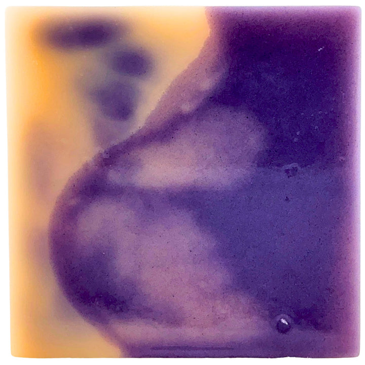 Close-up of a purple soap bar with a blurred background