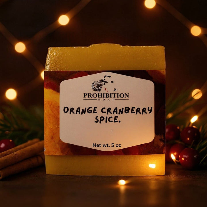 Prohibition Soap Orange Cranberry Spice soap bar with festive lights and decorations in the background