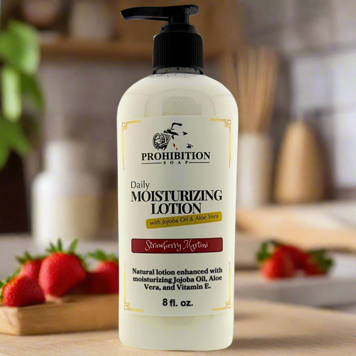 Prohibition Soap Daily Moisturizing Lotion in Strawberry Martini scent with 8 fl oz pump bottle on wooden cutting board with fresh strawberries, showing natural lotion enhanced with jojoba oil, aloe vera, and vitamin E in warm kitchen setting