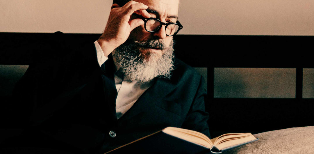 Man with a beard reading a book