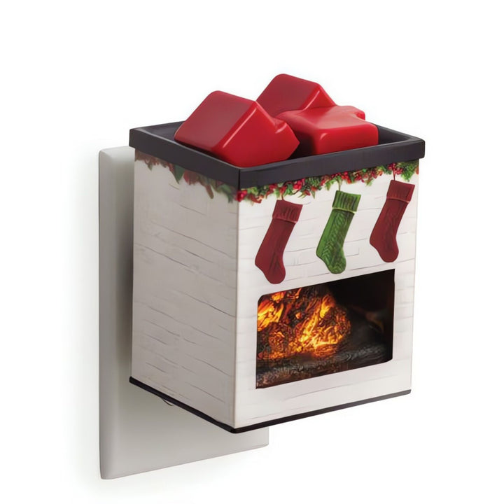 Decorative wall-mounted fireplace fragrance warmer with Christmas stockings and red wax melts on a white background