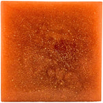 Square piece of orange soap with a sparkly surface