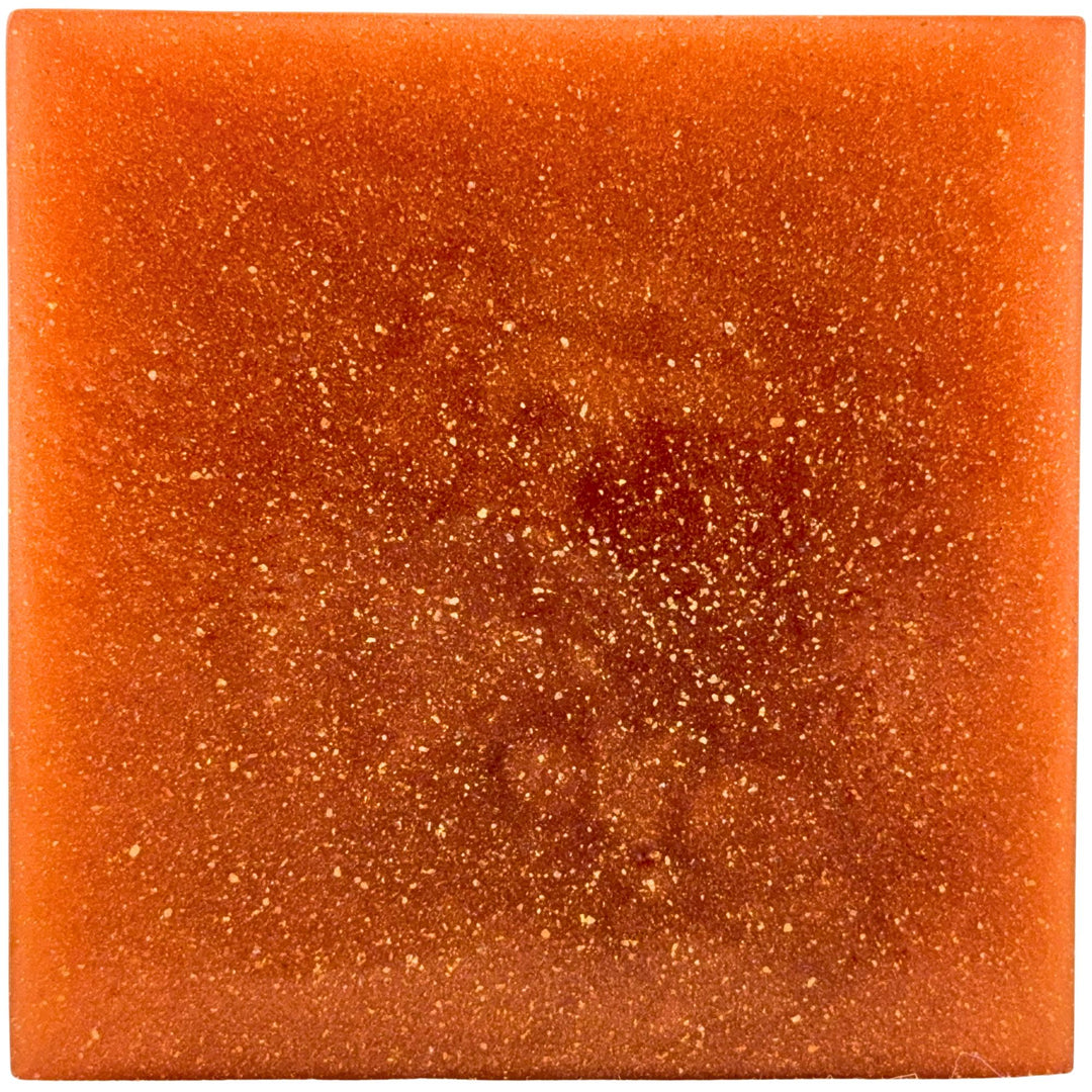 Square piece of orange soap with a sparkly surface