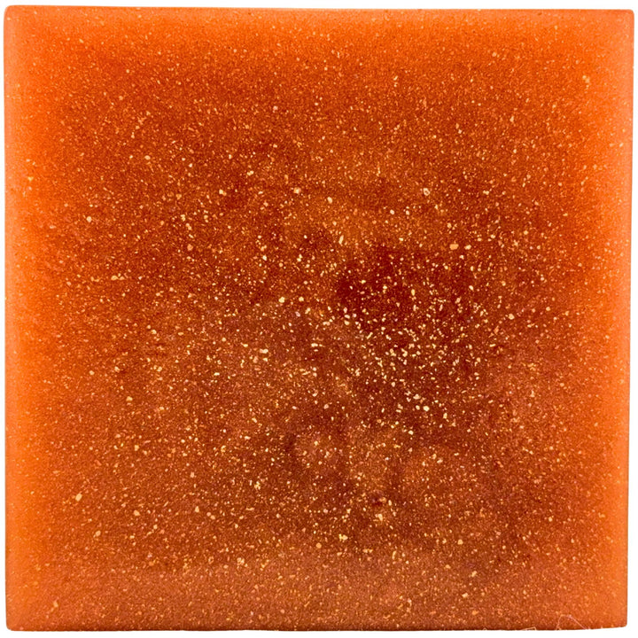 Square piece of orange soap with a sparkly surface