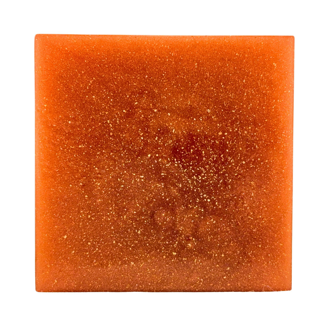 Square piece of orange soap on a white background