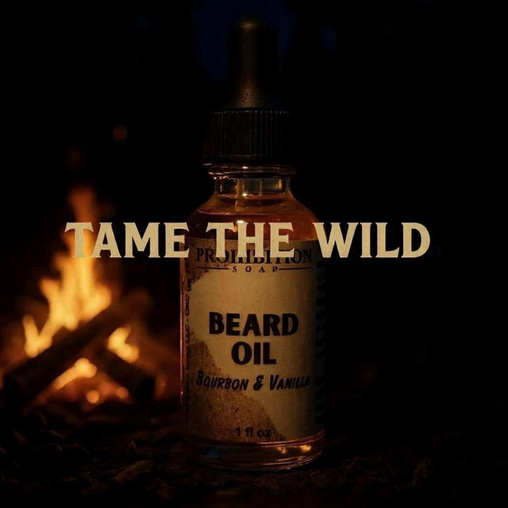 Prohibition Soap Bourbon & Vanilla Beard Oil 'Tame the Wild' marketing image featuring product bottle with campfire flames in background on dark atmospheric setting