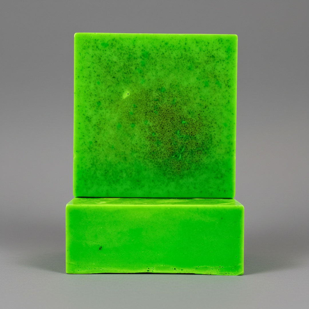 Two green soaps stacked on a gray background