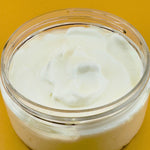 Prohibition Soap Daily Body Cream open jar showing thick, creamy white texture of natural yogurt-based formula with jojoba oil and aloe vera, photographed on golden yellow background