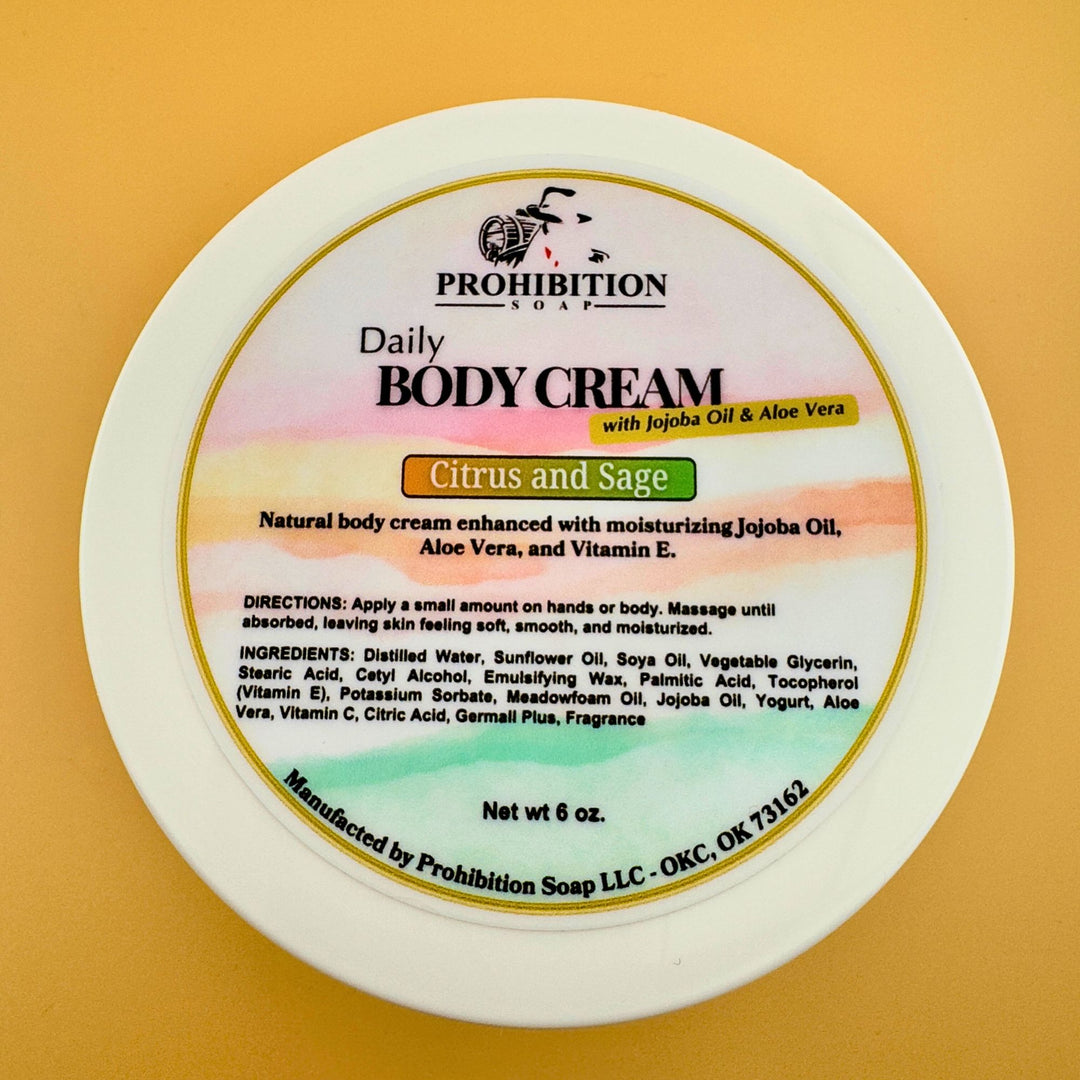 Prohibition Soap Daily Body Cream label showing Citrus and Sage scent with complete ingredients list including jojoba oil, aloe vera, and vitamin E, featuring colorful gradient design and product directions on golden background