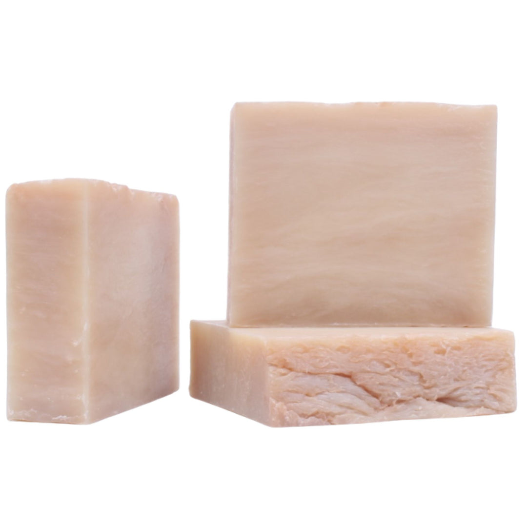 Three bars of soap with different textures on a white background