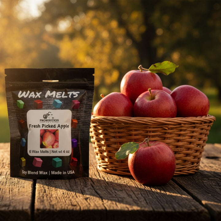 Wax melts packaging with a basket of apples on a wooden surface outdoors.