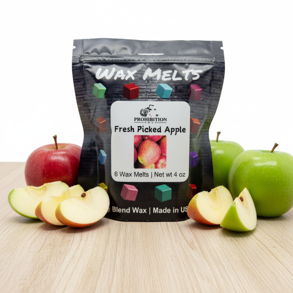 Packaging of Prohibition Soap Wax Melts Fresh Picked Apple flavor with apples on a wooden surface