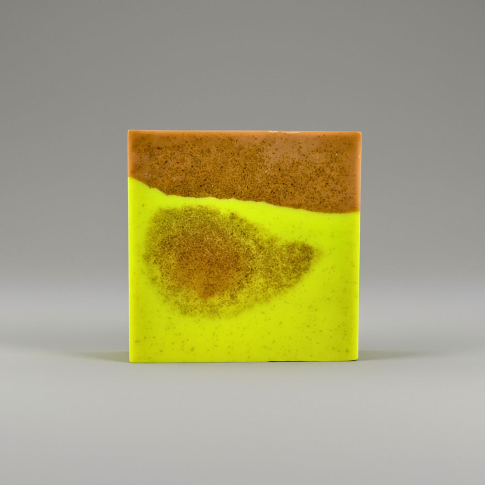 Two-tone soap with yellow and brown on a gray background