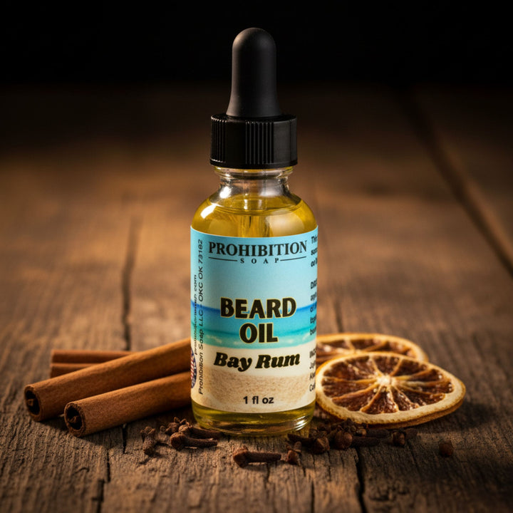 Bottle of Prohibition Soap beard oil with cinnamon sticks and dried oranges on a wooden surface