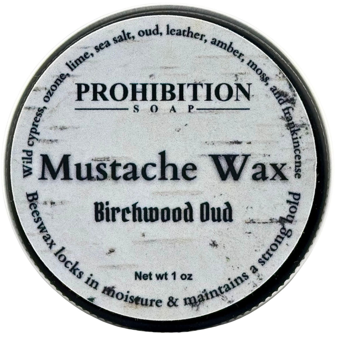 A round metal tin of Prohibition Soap Mustache Wax in Birchwood Oud scent, viewed from directly above against a white background.