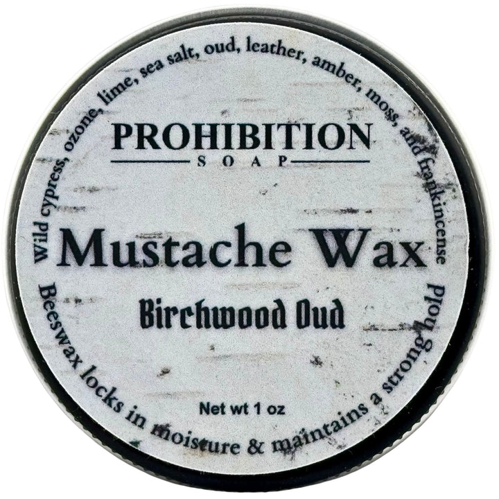 A round metal tin of Prohibition Soap Mustache Wax in Birchwood Oud scent, viewed from directly above against a white background.