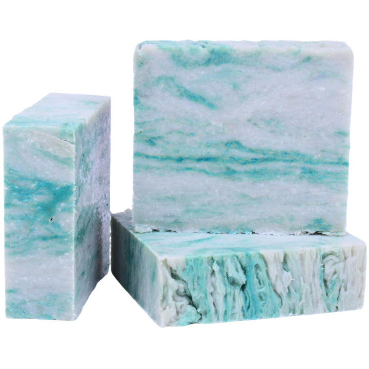 Three bars of marbled soap with blue and white pattern on a white background