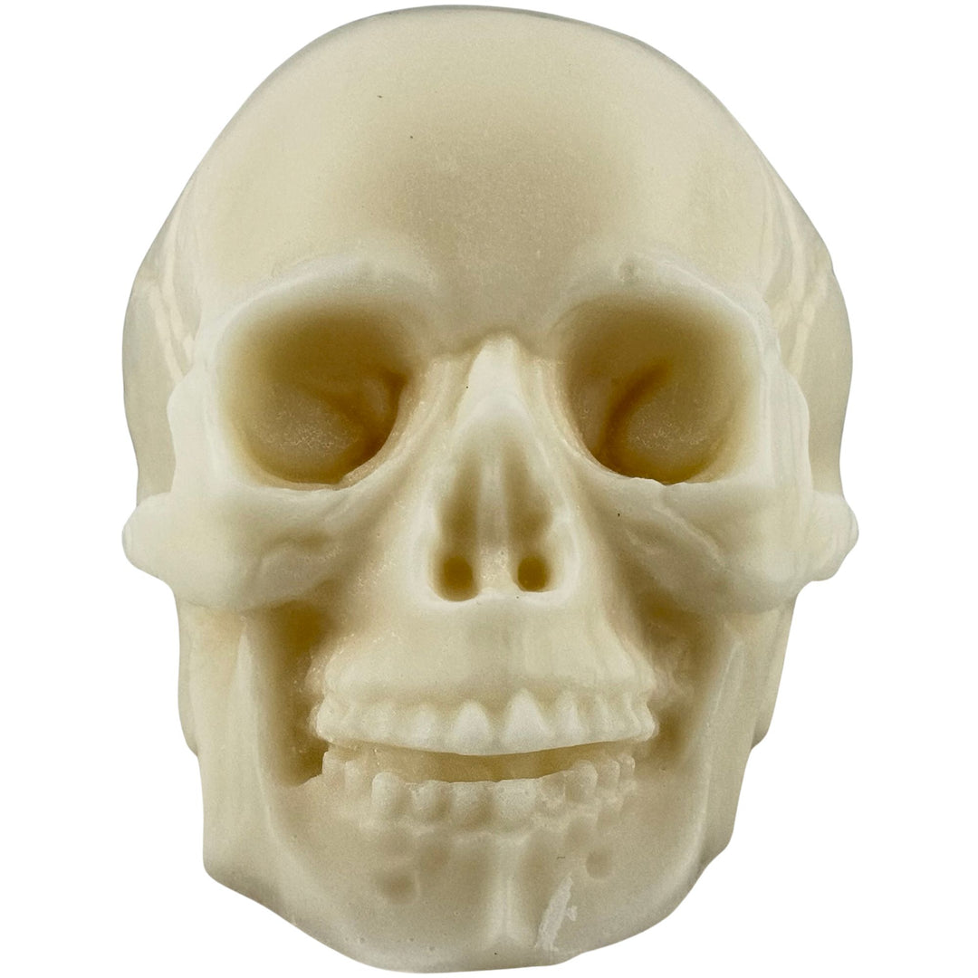 An off-white, bone-colored skull soap shown from a front-facing perspective against a solid white background.