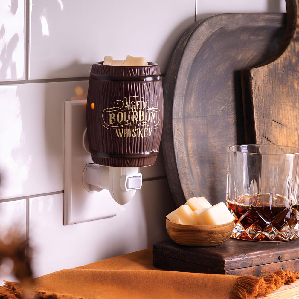 Wall-mounted bourbon-themed wax warmer with a glass of bourbon on a wooden surface.