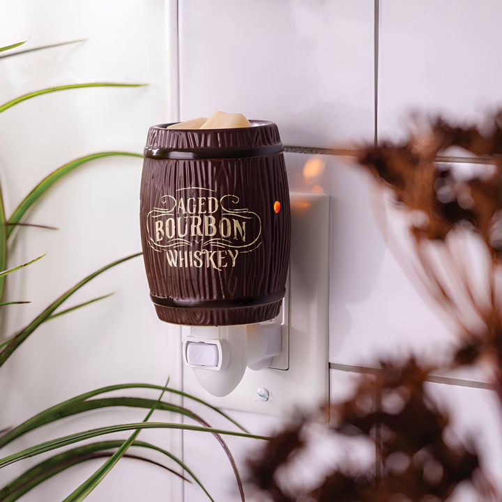 Decorative fragrance warmer shaped like a barrel with 'Aged Bourbon Whiskey' text, mounted on a wall.