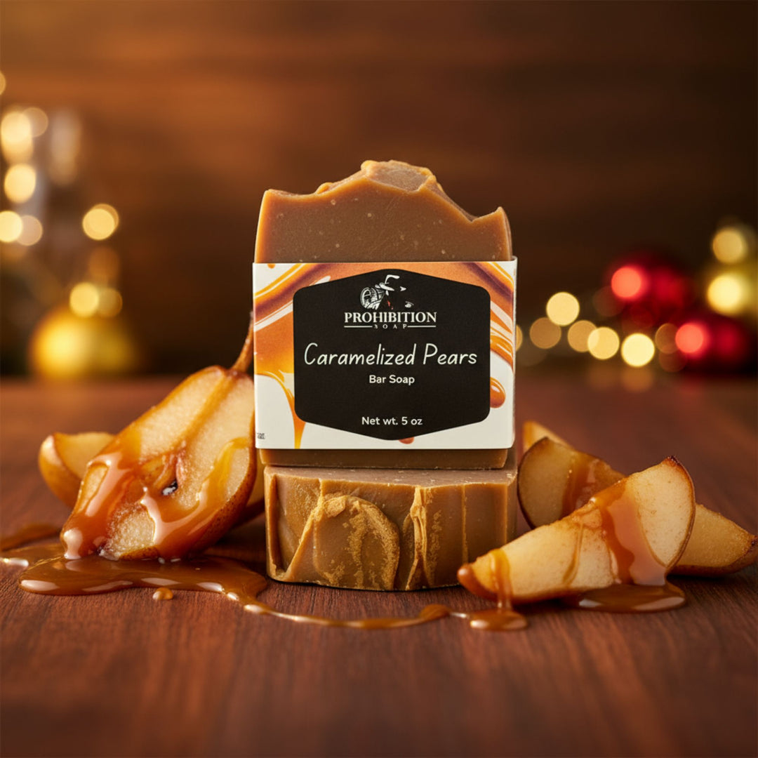 Bar of soap with 'Caramelized Pears' packaging on a wooden surface with pears and caramel sauce.