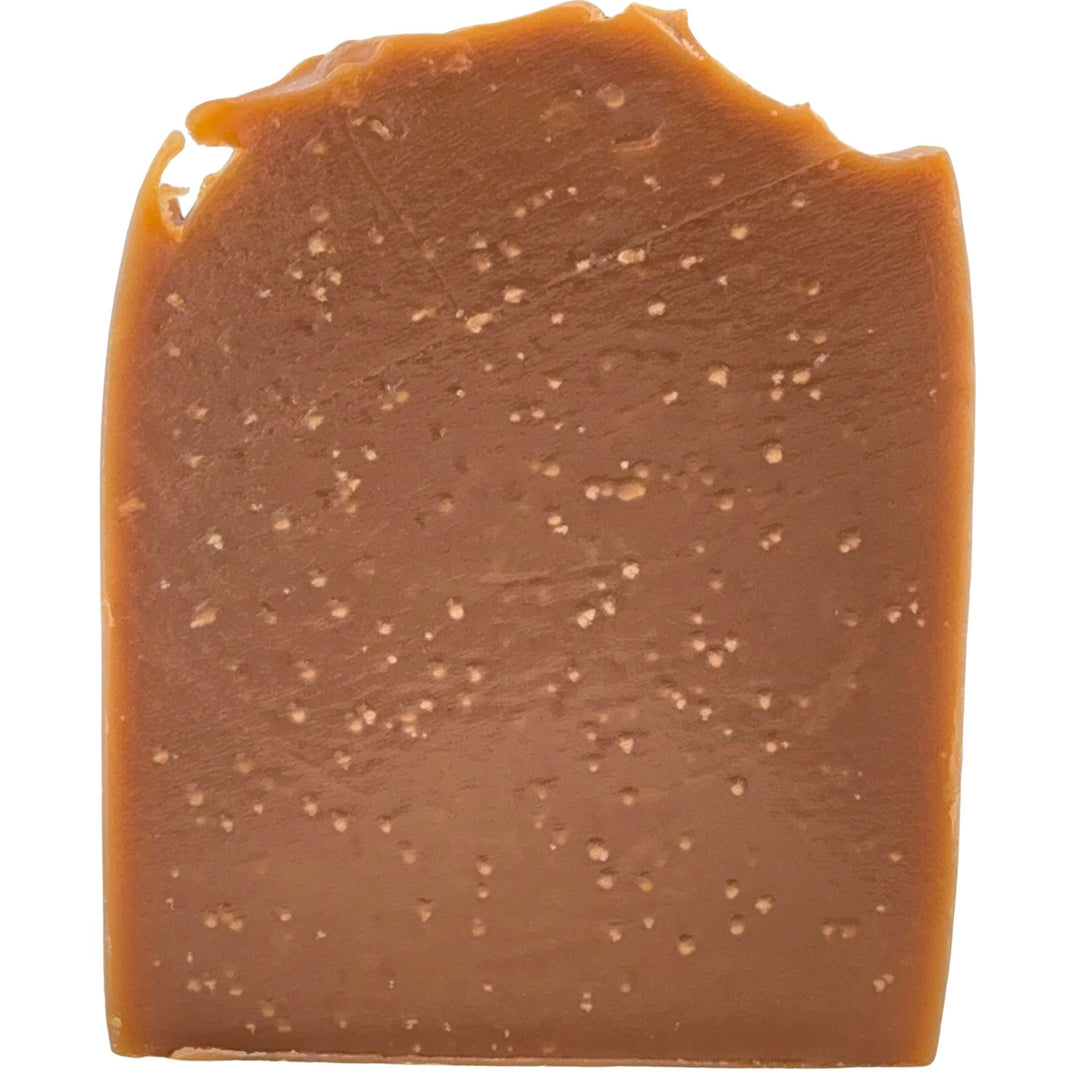 Brown bar of soap with a textured surface on a white background
