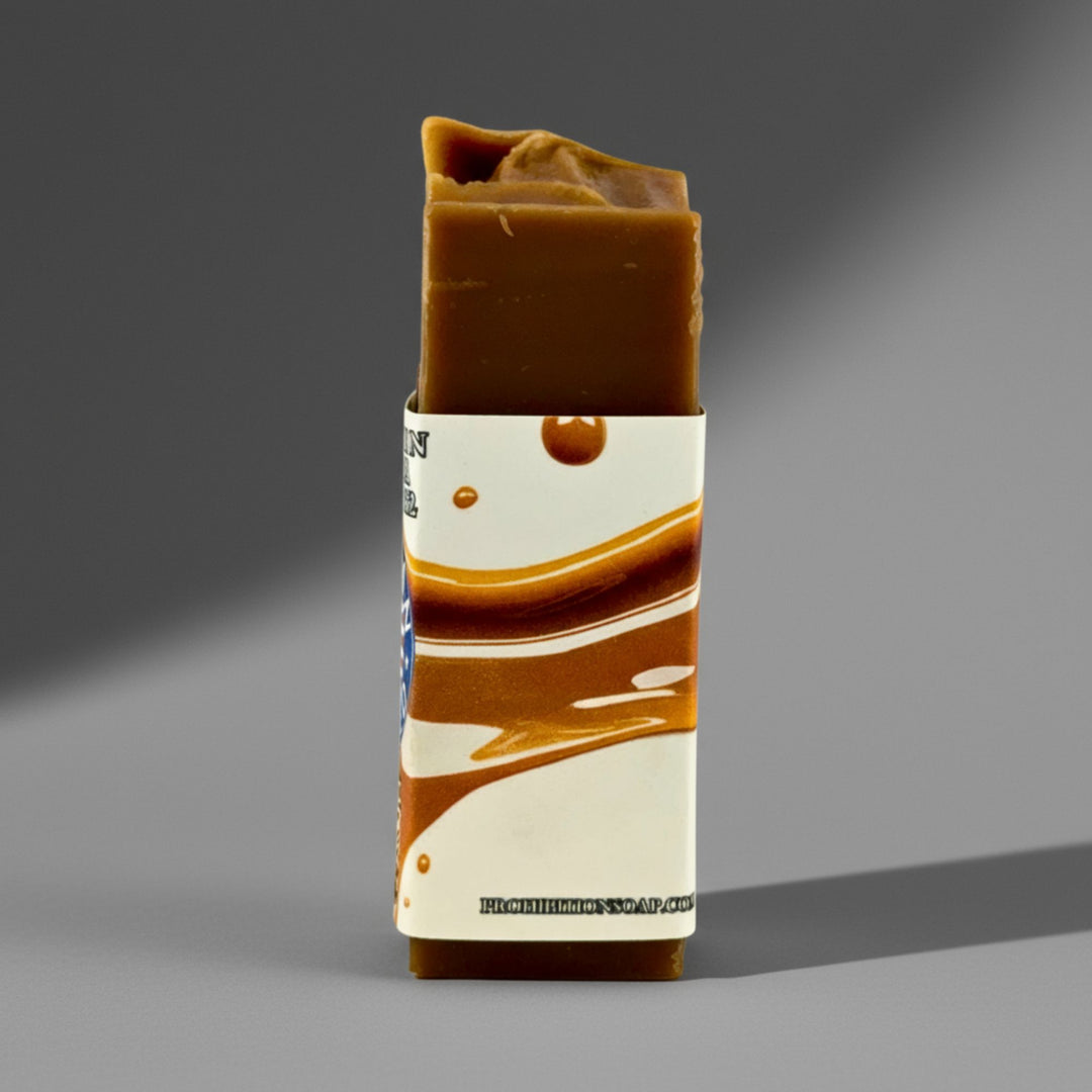 Bar of soap with a decorative label on a gray background