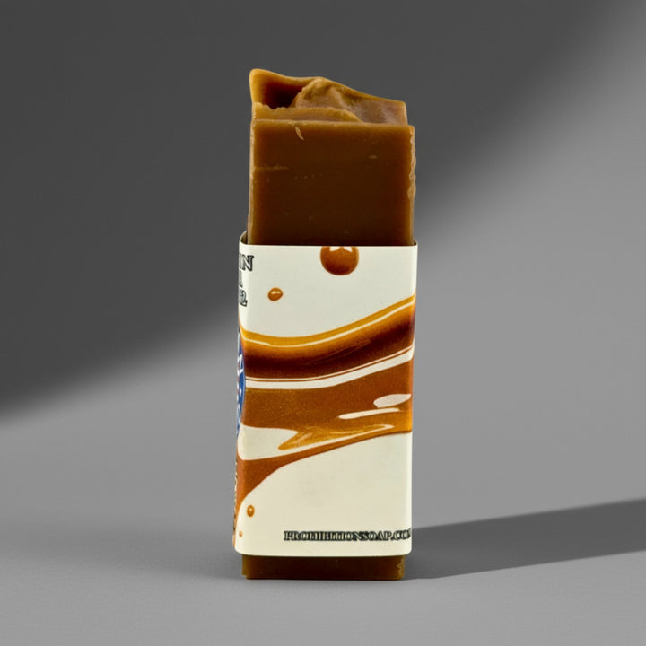 Bar of soap with a decorative label on a gray background