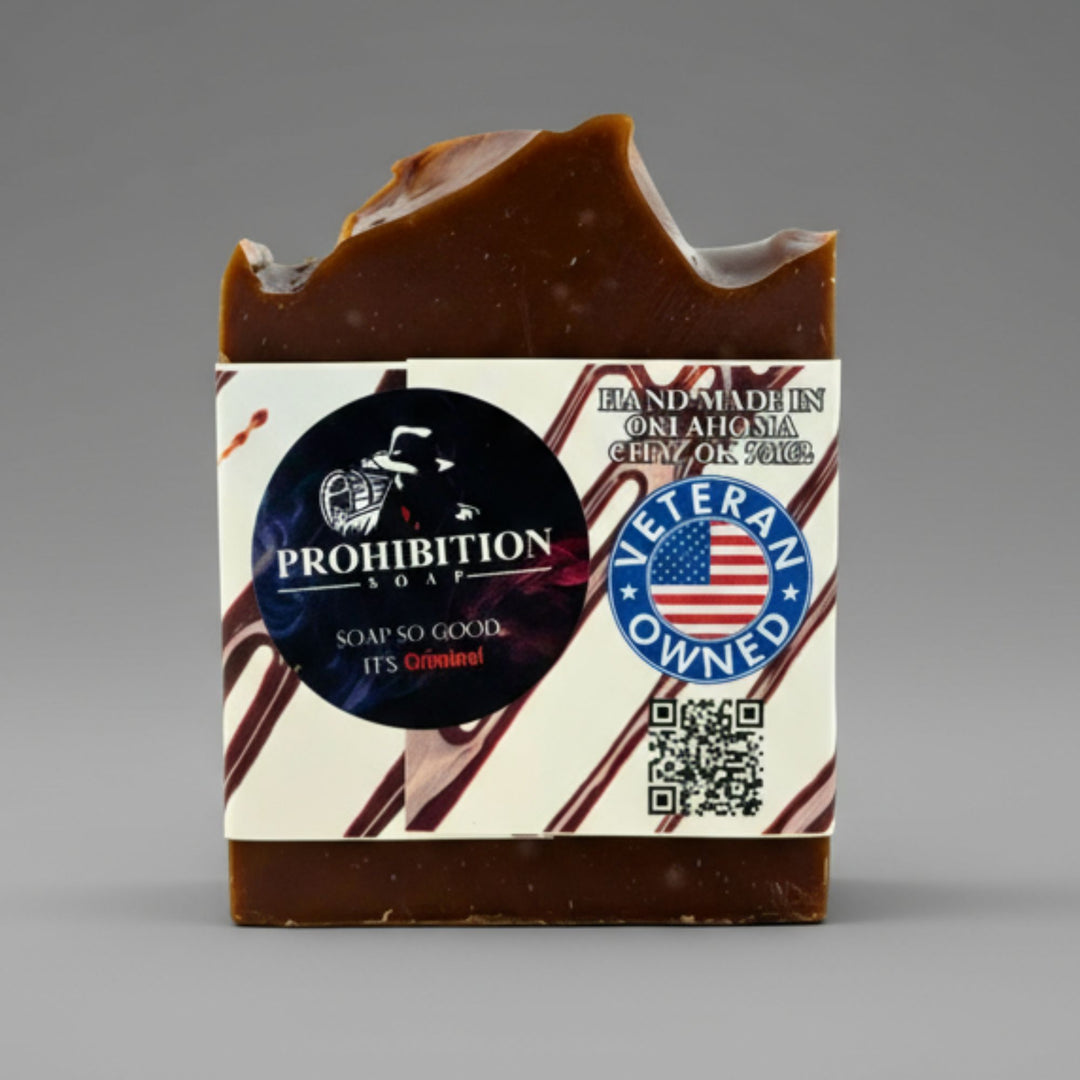Bar of soap with a label featuring 'Prohibition Soap' branding and a 'Veteran Owned' badge on a gray background.