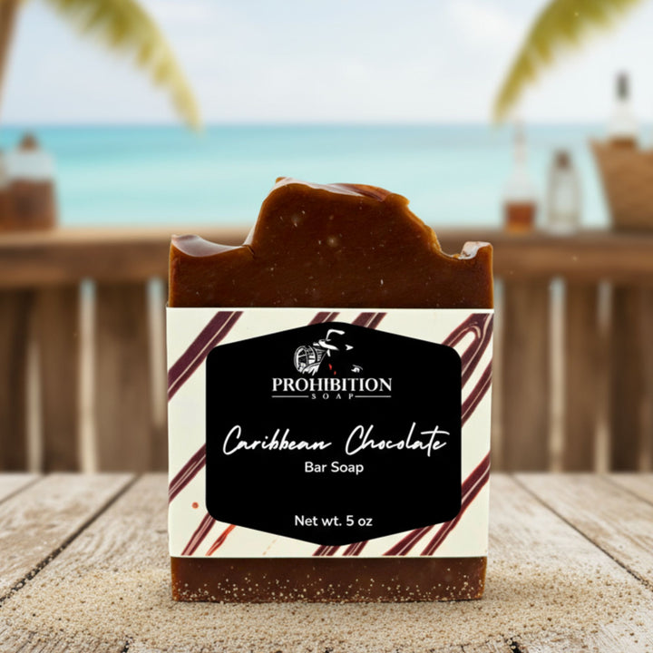 Caribbean Chocolate bar soap with Prohibition Soap label on a wooden surface with an ocean view