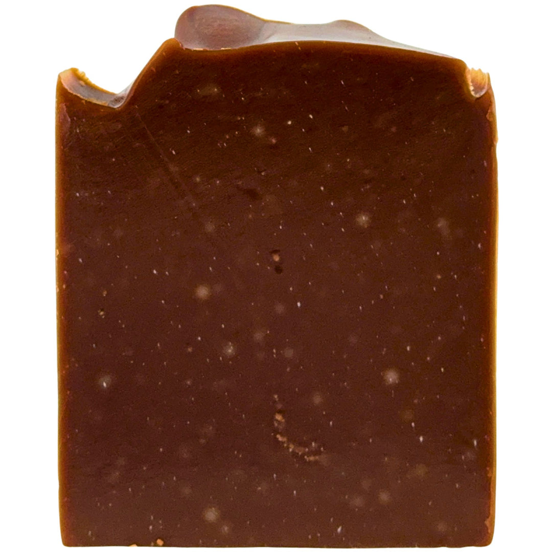 Close-up of a square piece of chocolate scented soap on a white background