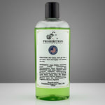 A bottle of Prohibition Soap Shower Gel with light green gel, a white label, and a black cap, set against a neutral gray background.