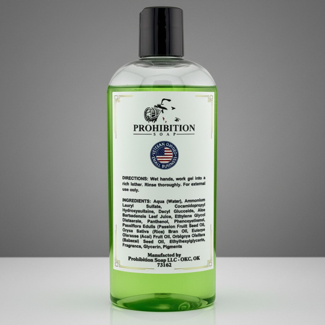 A bottle of Prohibition Soap Shower Gel with light green gel, a white label, and a black cap, set against a neutral gray background.