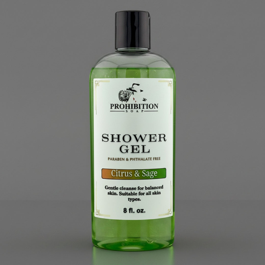 A bottle of Prohibition Soap Shower Gel in the Citrus & Sage scent, featuring a clear bottle filled with green gel and a white label, set against a solid gray background.