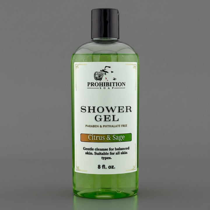 A bottle of Prohibition Soap Shower Gel in the Citrus &amp; Sage scent, featuring a clear bottle filled with green gel and a white label, set against a solid gray background.
