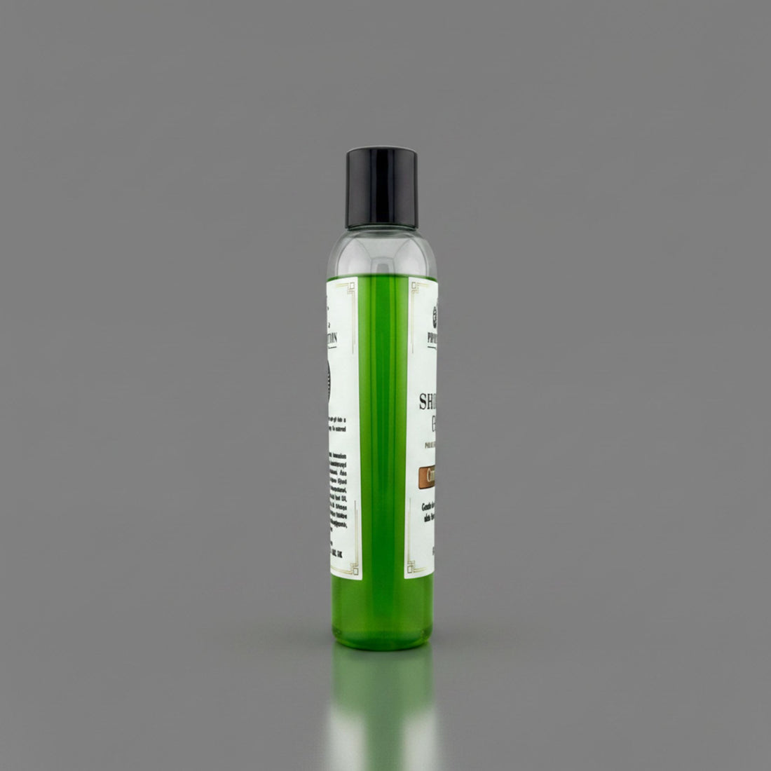 A clear plastic bottle filled with bright green gel, featuring a black cap and a white label, standing upright on a reflective gray surface against a solid gray background.