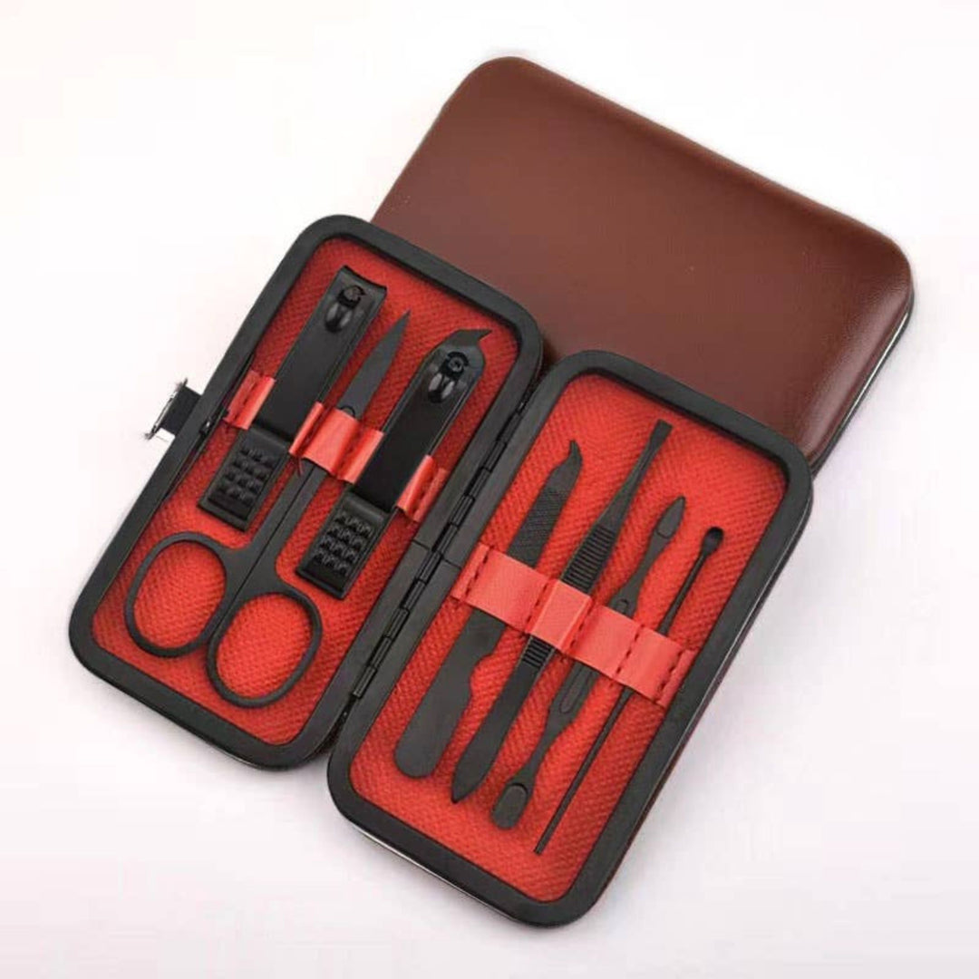 Manicure set with black tools in a red case on a white background