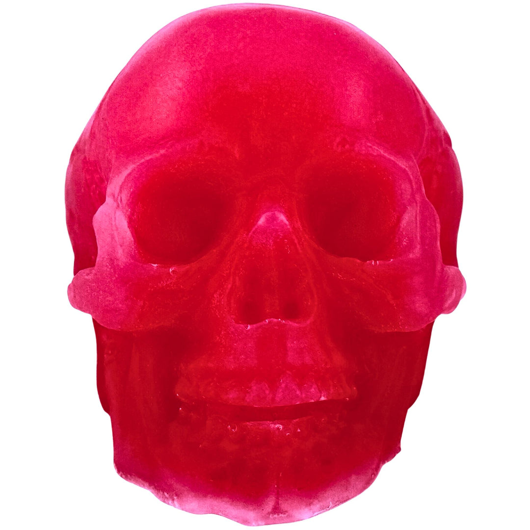 A glossy, translucent hot pink skull-shaped soap isolated on a solid white background.