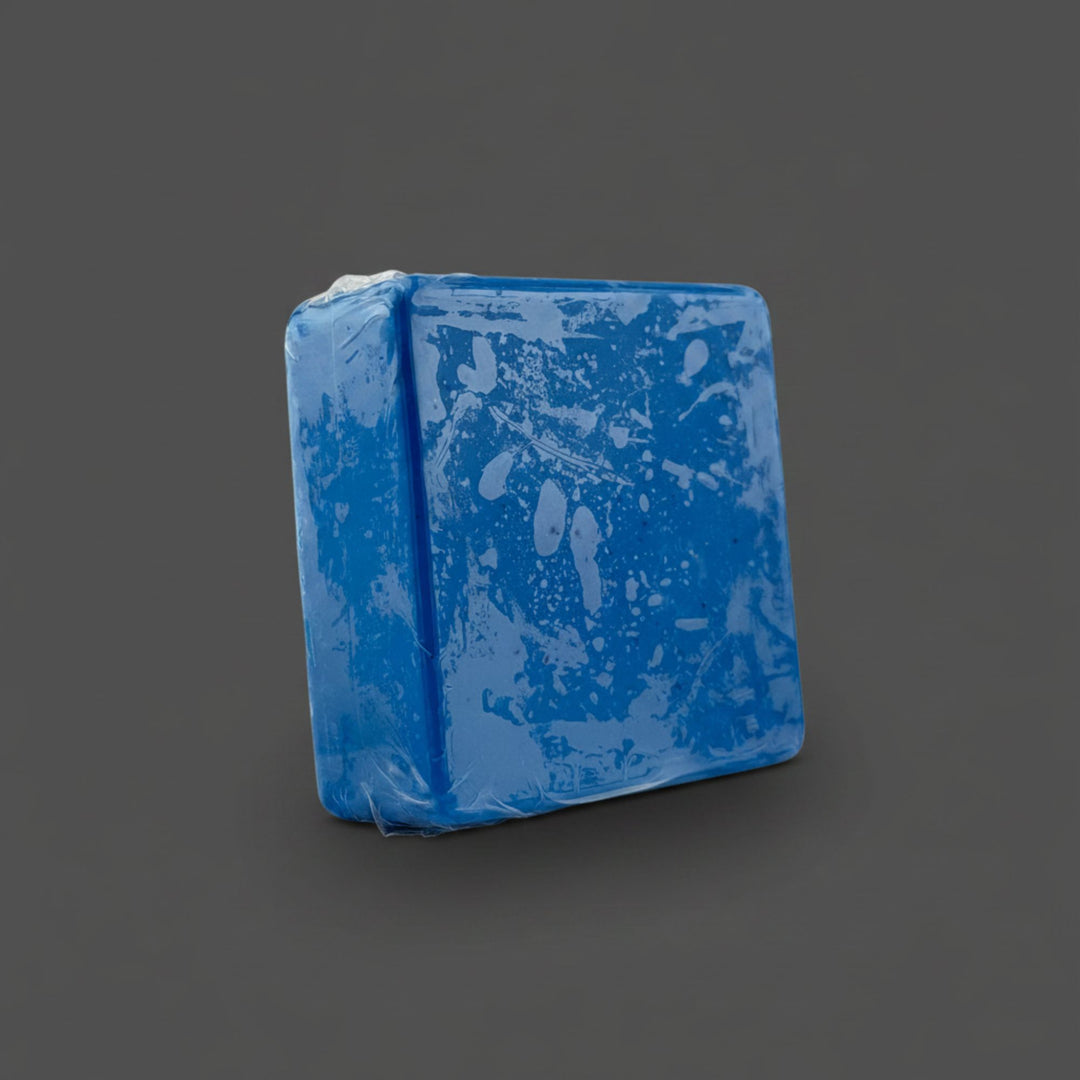 Blue rectangular soap with a textured surface on a grey background