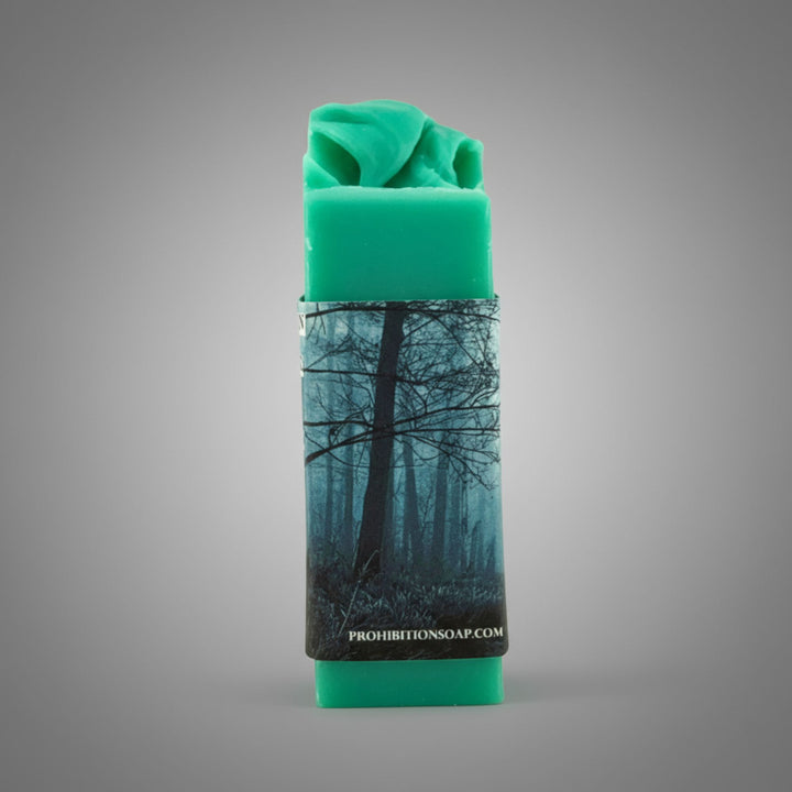 Green soap bar with a forest design on a gray background
